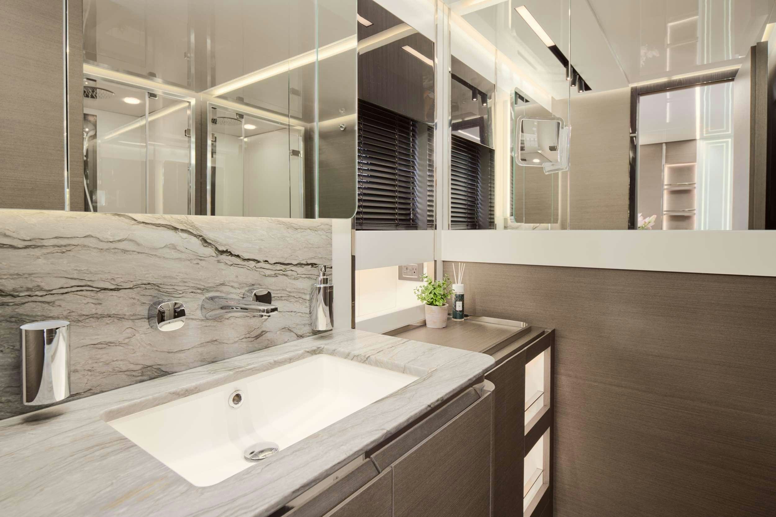 a bathroom with a large mirror aboard MYNE Yacht for Charter