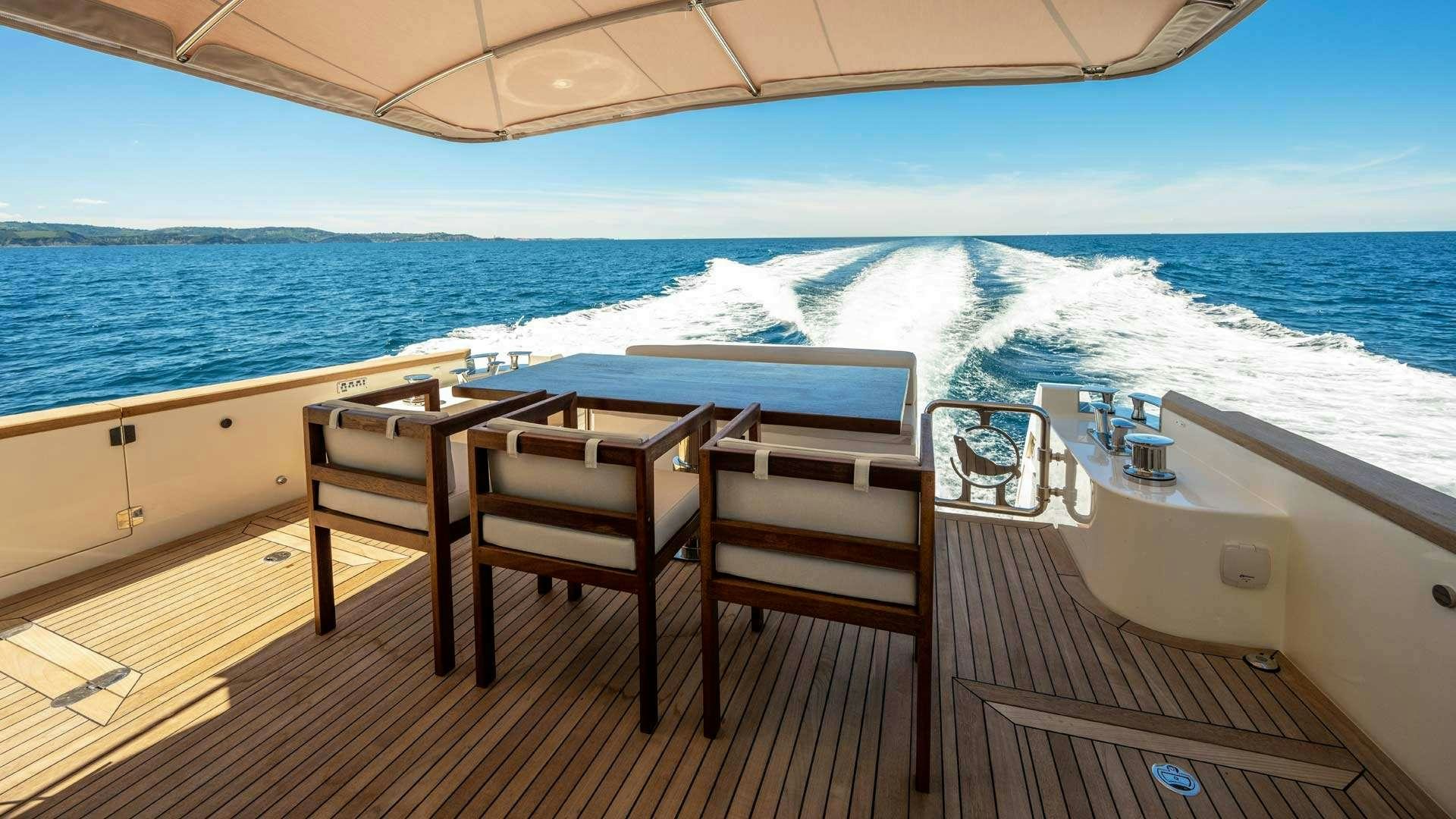 a table and chairs on a boat aboard PANTA REI Yacht for Charter
