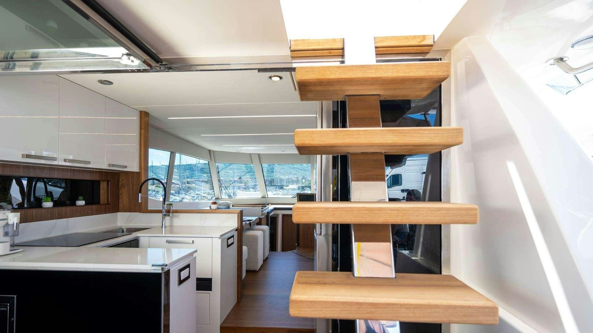 a kitchen with a wood shelf aboard PANTA REI Yacht for Charter