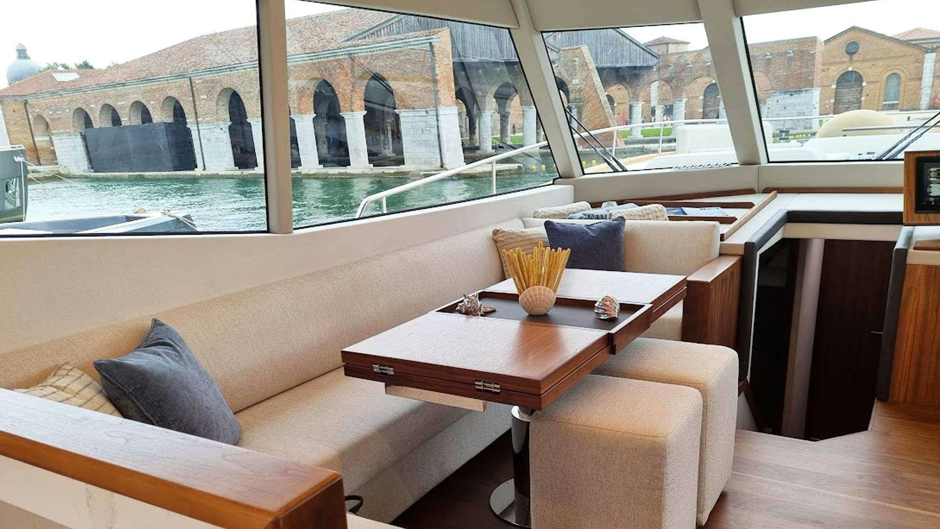 a room with a table and chairs aboard PANTA REI Yacht for Charter