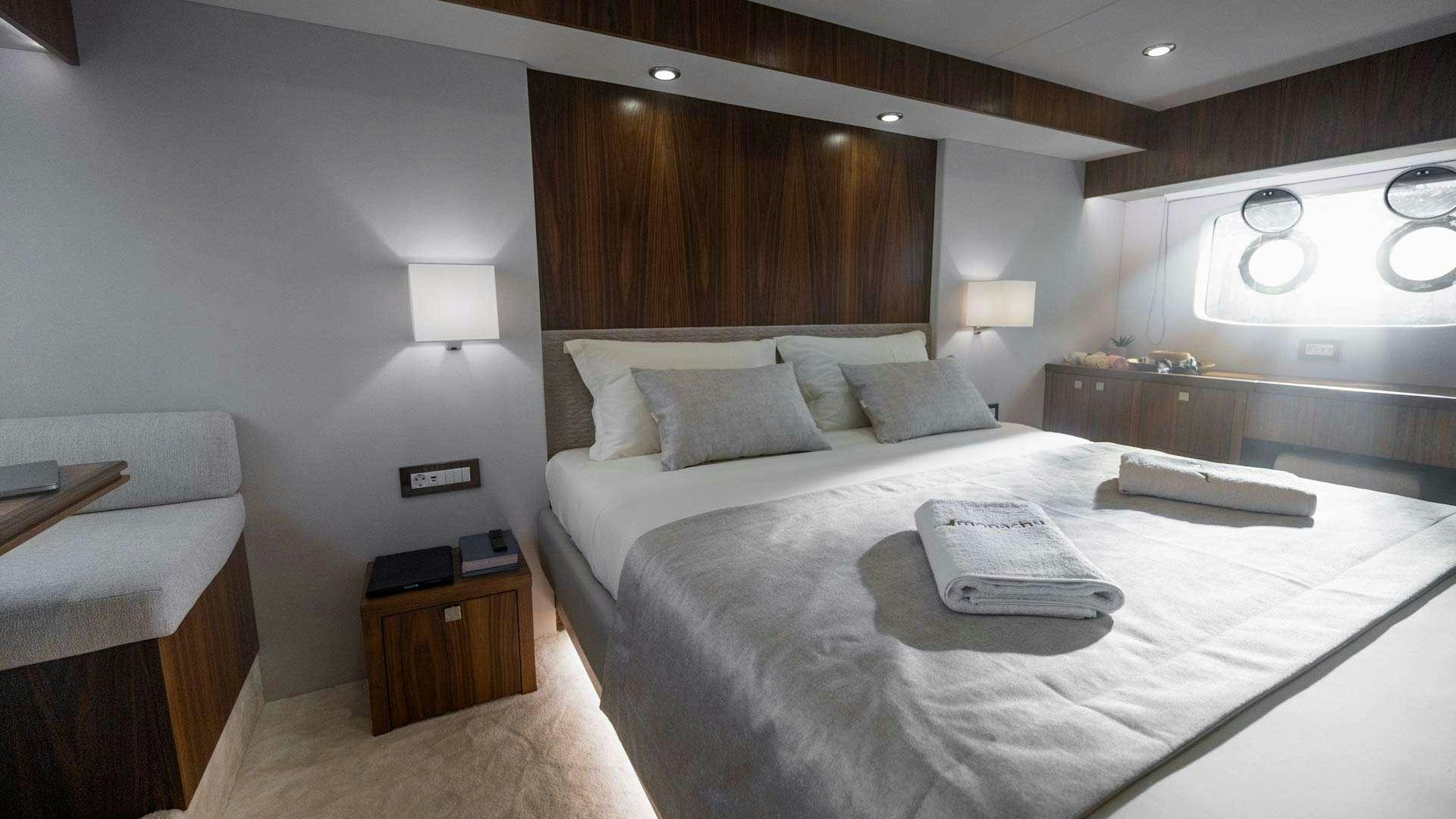 a bed with a white sheet and a white pillow on it aboard PANTA REI Yacht for Charter