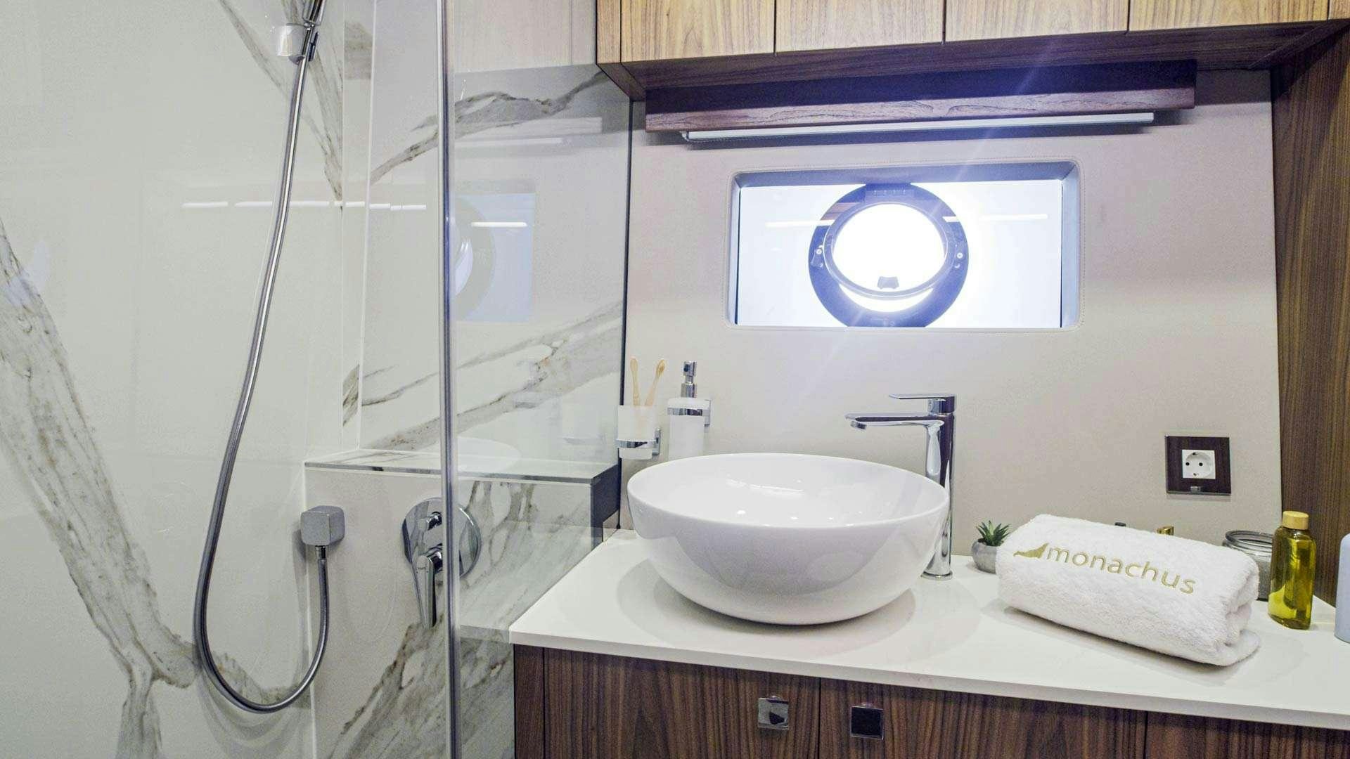 a bathroom with a sink and a mirror aboard PANTA REI Yacht for Charter