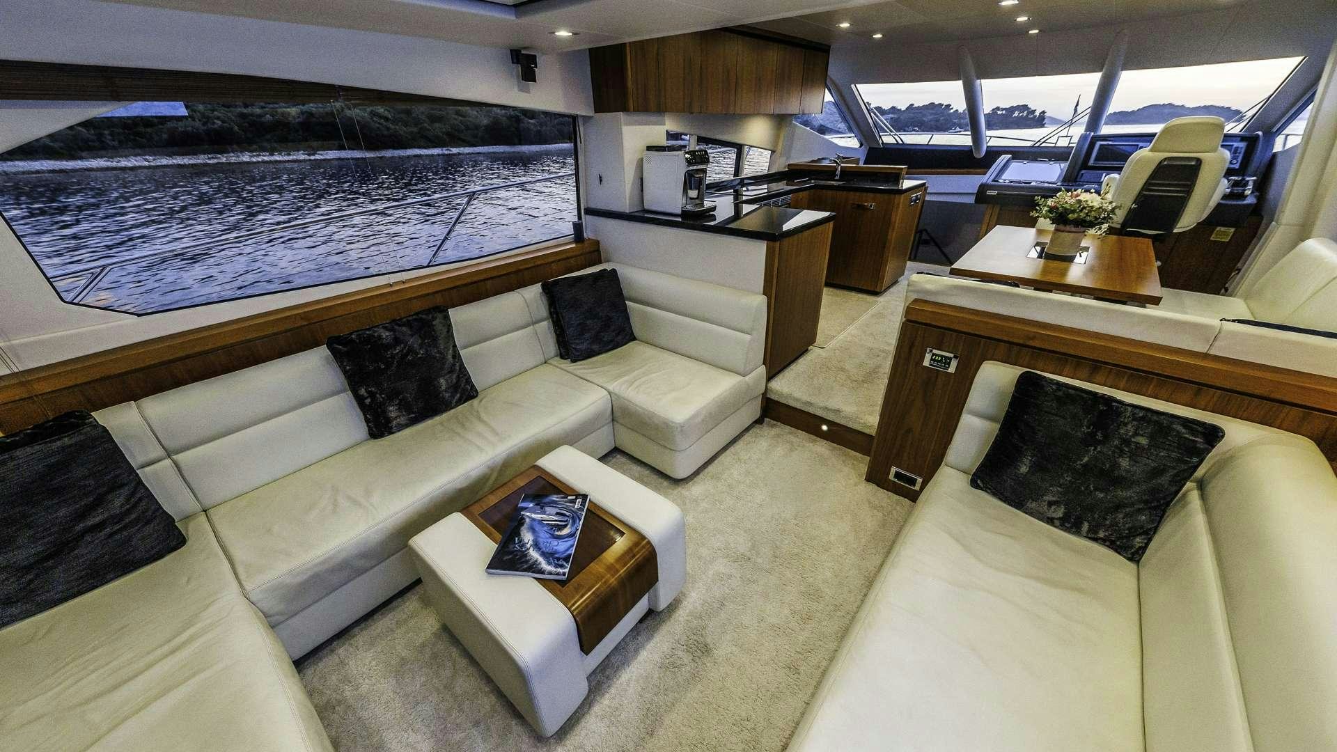 a room with a couch and a bed aboard 2 DRUNK Yacht for Charter
