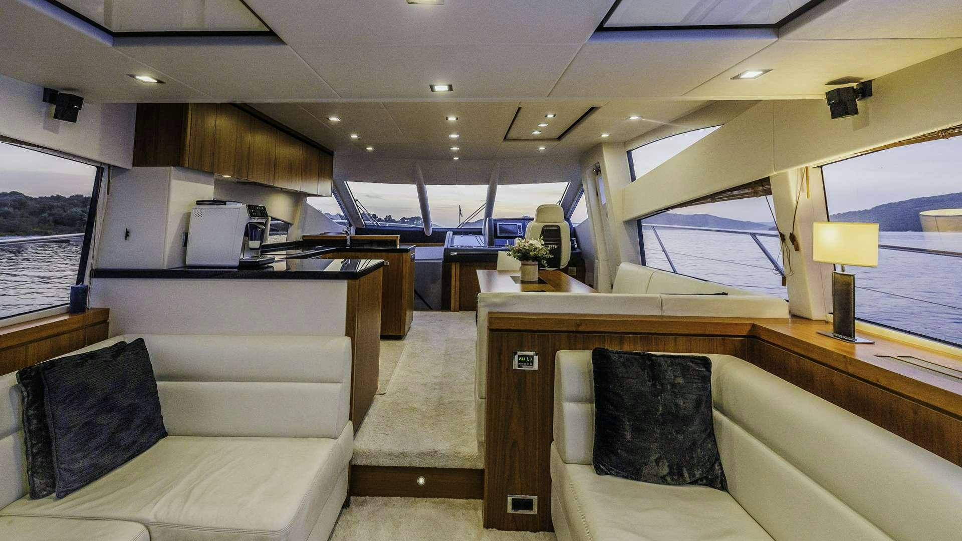 a room with a couch and a desk aboard 2 DRUNK Yacht for Charter