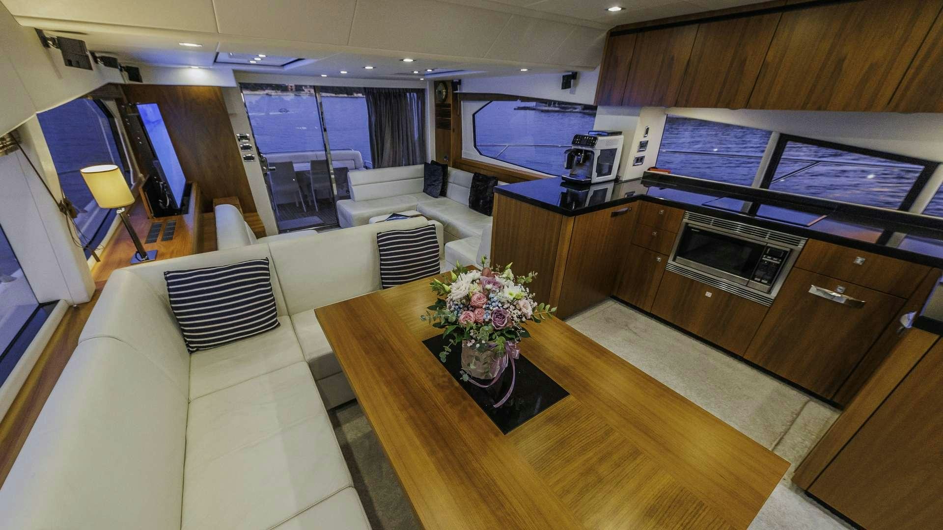a large room with a couch and a table aboard 2 DRUNK Yacht for Charter