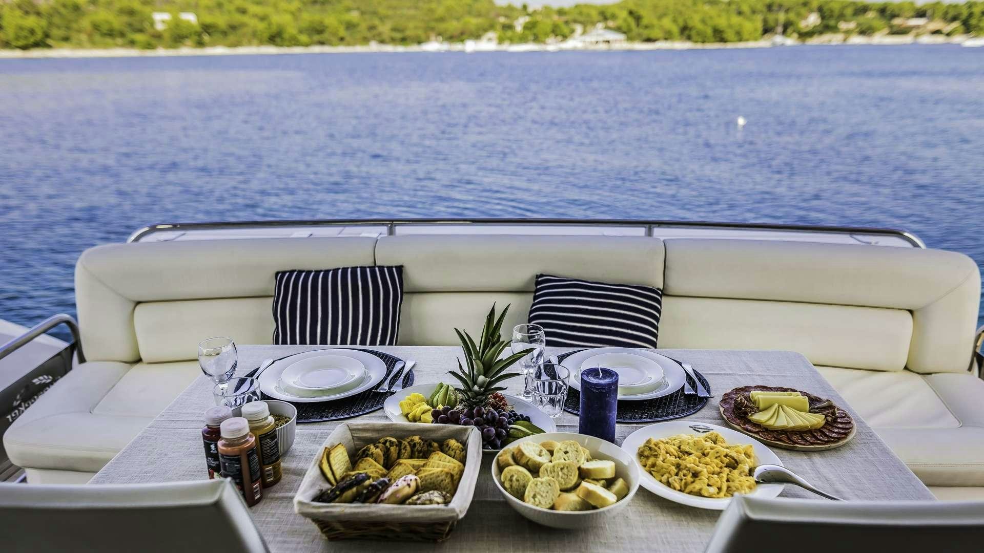 a table with food on it aboard 2 DRUNK Yacht for Charter