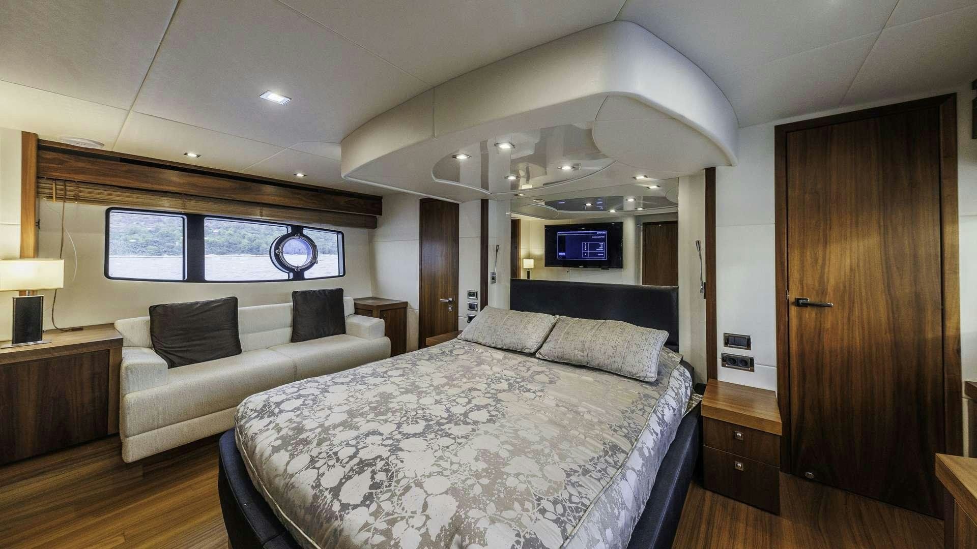 a bedroom with a bed and a couch aboard 2 DRUNK Yacht for Charter