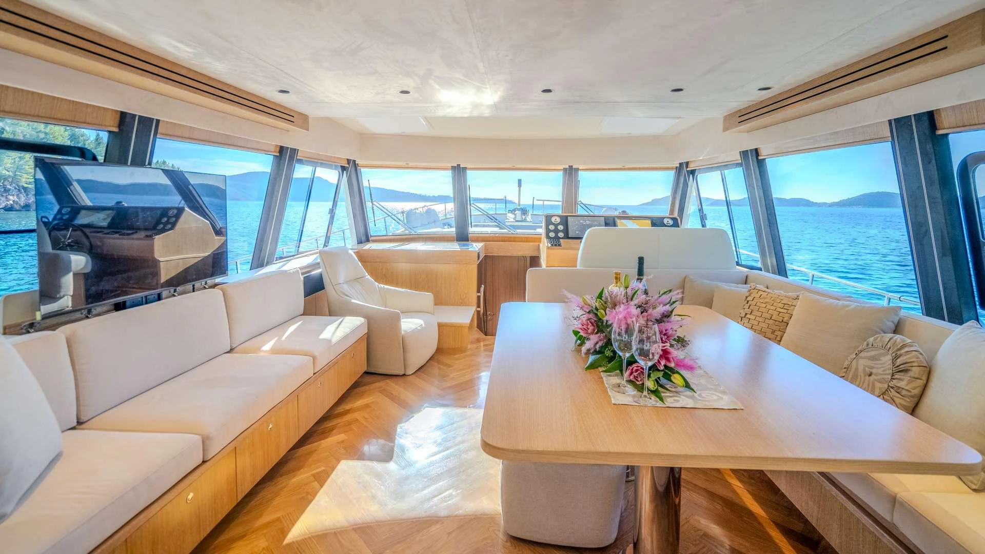 a living room with a table and couches aboard CLOUD 9 Yacht for Charter