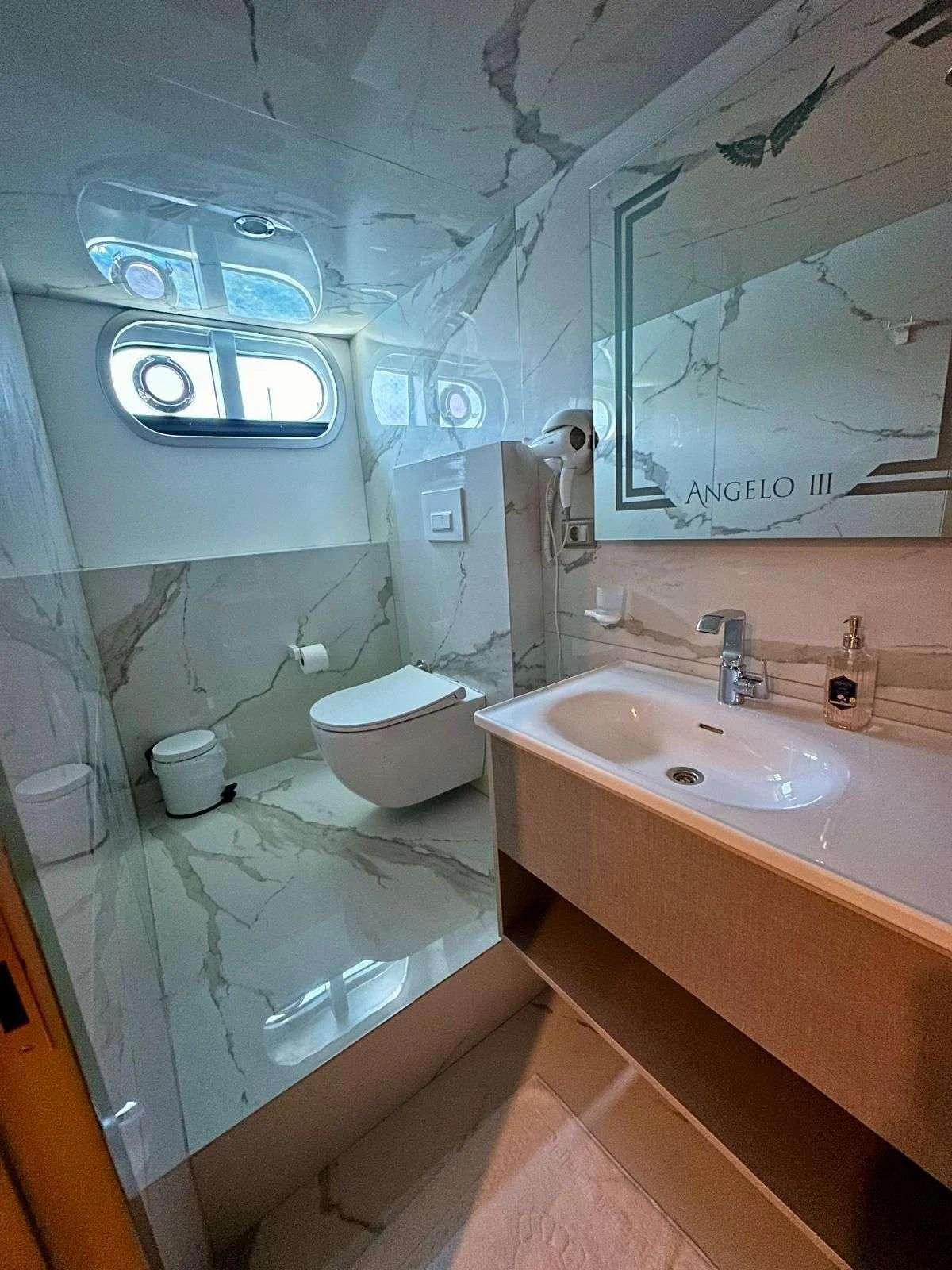 a bathroom with a tub sink and toilet aboard ANGELO 3 Yacht for Charter