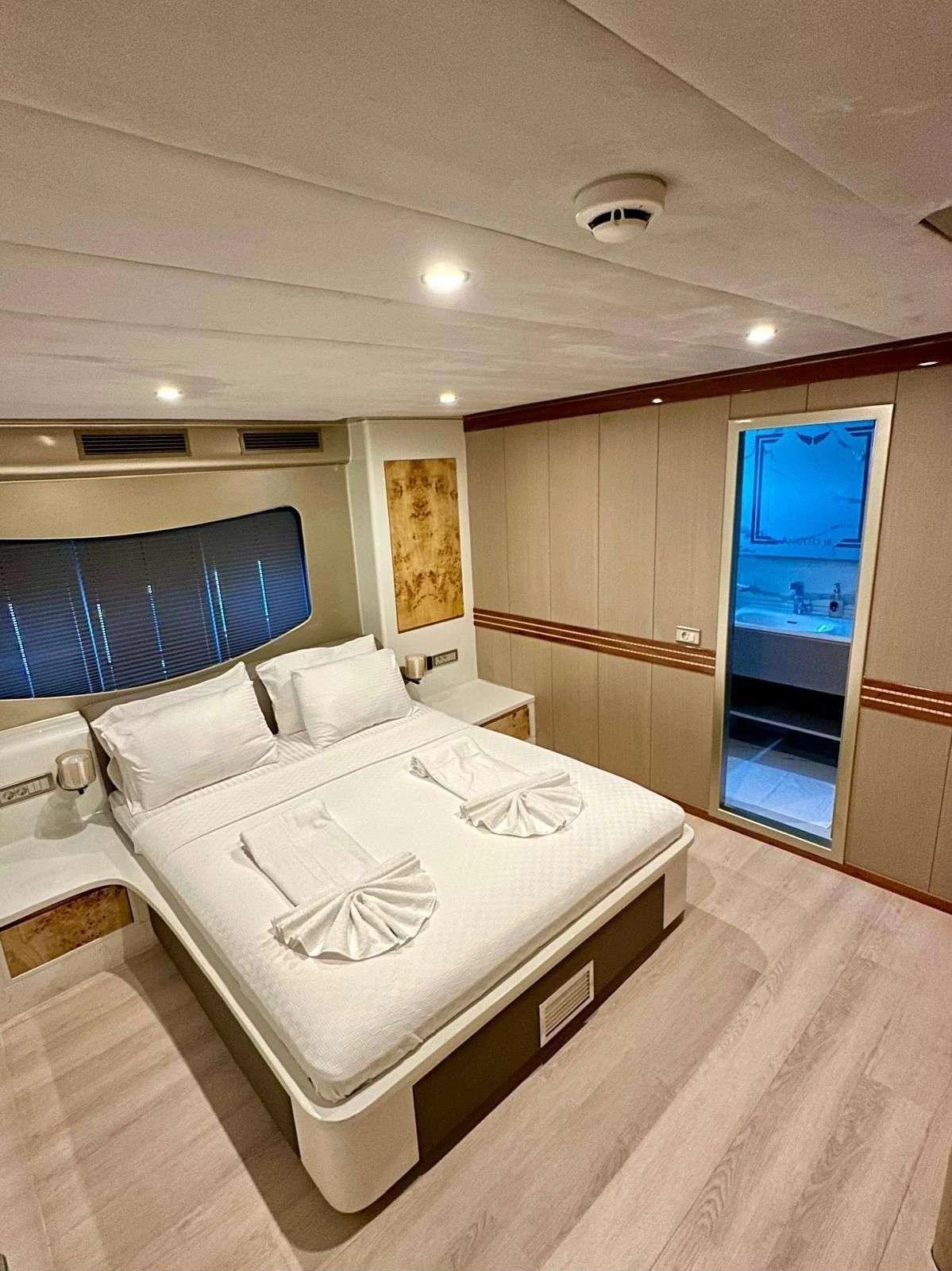 a bedroom with a bed and a door aboard ANGELO 3 Yacht for Charter