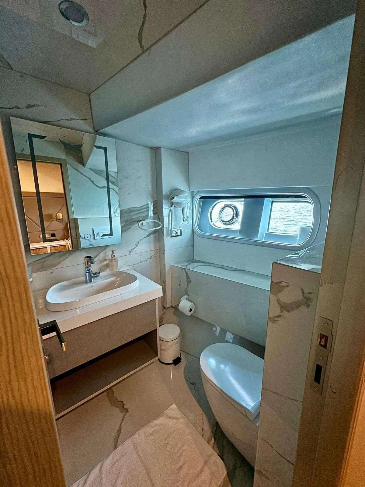 a bathroom with a sink and a mirror aboard ANGELO 3 Yacht for Charter