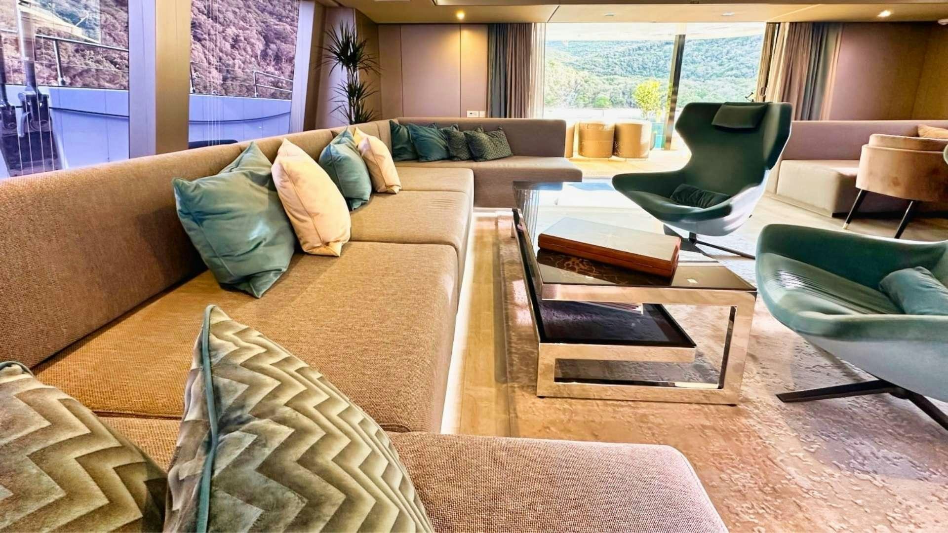 a living room with a couch and a table aboard HONEYBIRD Yacht for Charter
