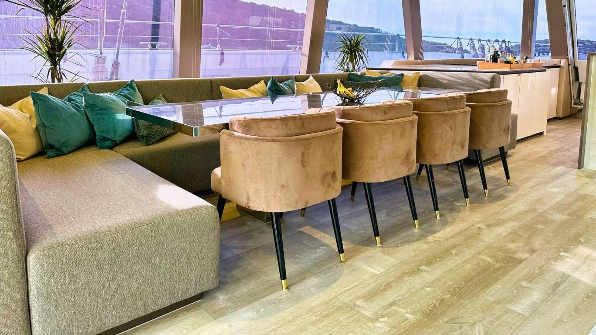 a room with couches and a table aboard HONEYBIRD Yacht for Charter