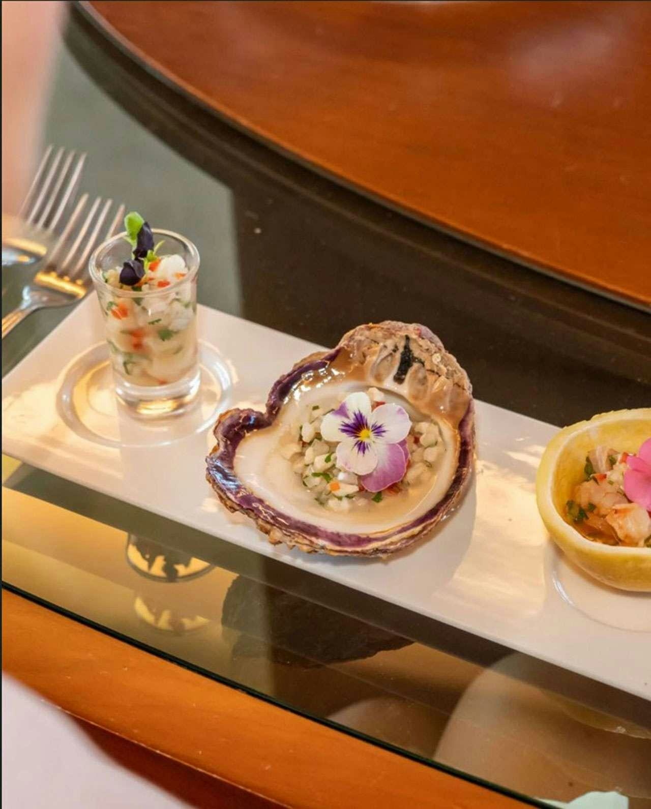 a plate of food and a glass of water on a table aboard CAMY ED Yacht for Charter