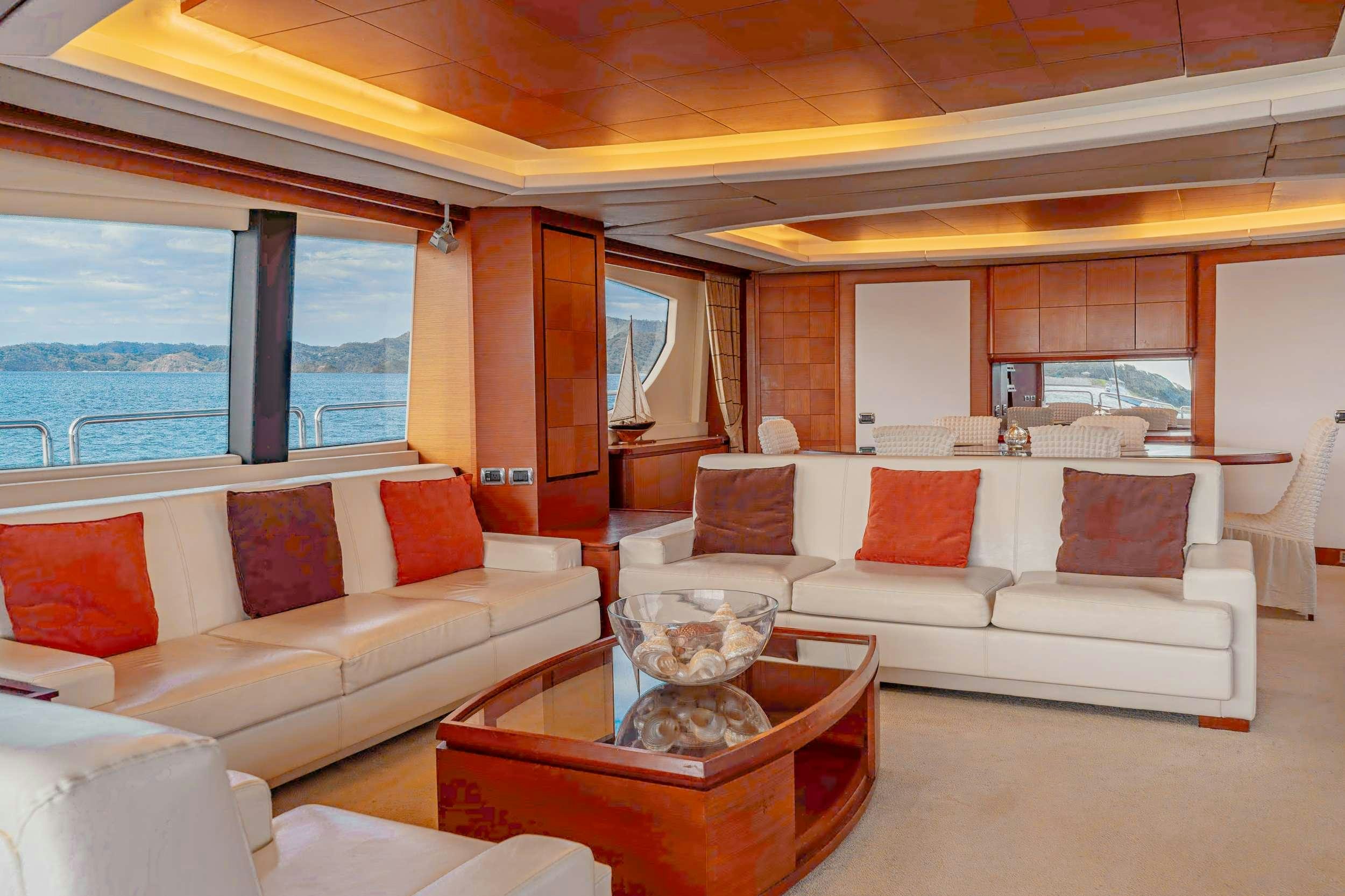 a living room with a large window aboard CAMY ED Yacht for Charter