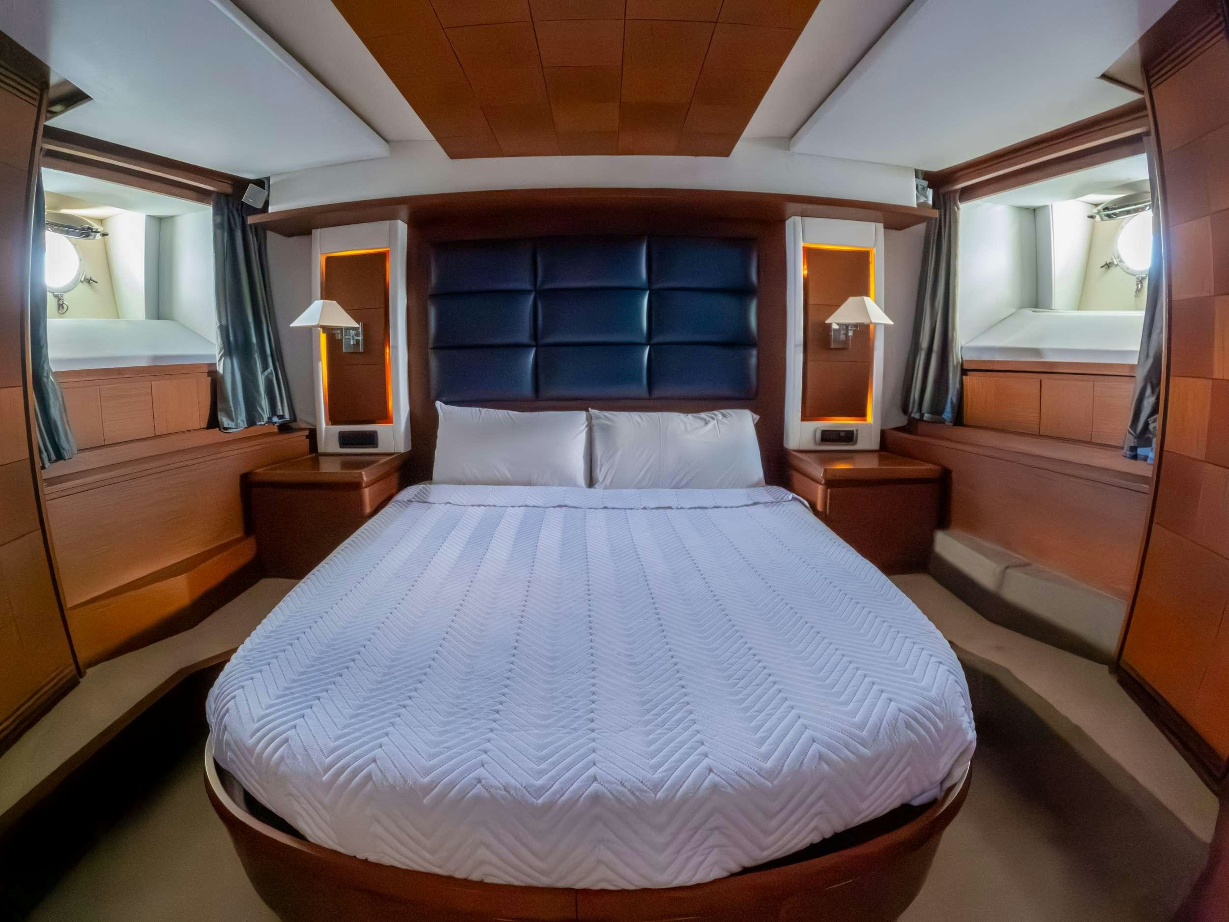 a bed with a white sheet aboard CAMY ED Yacht for Charter