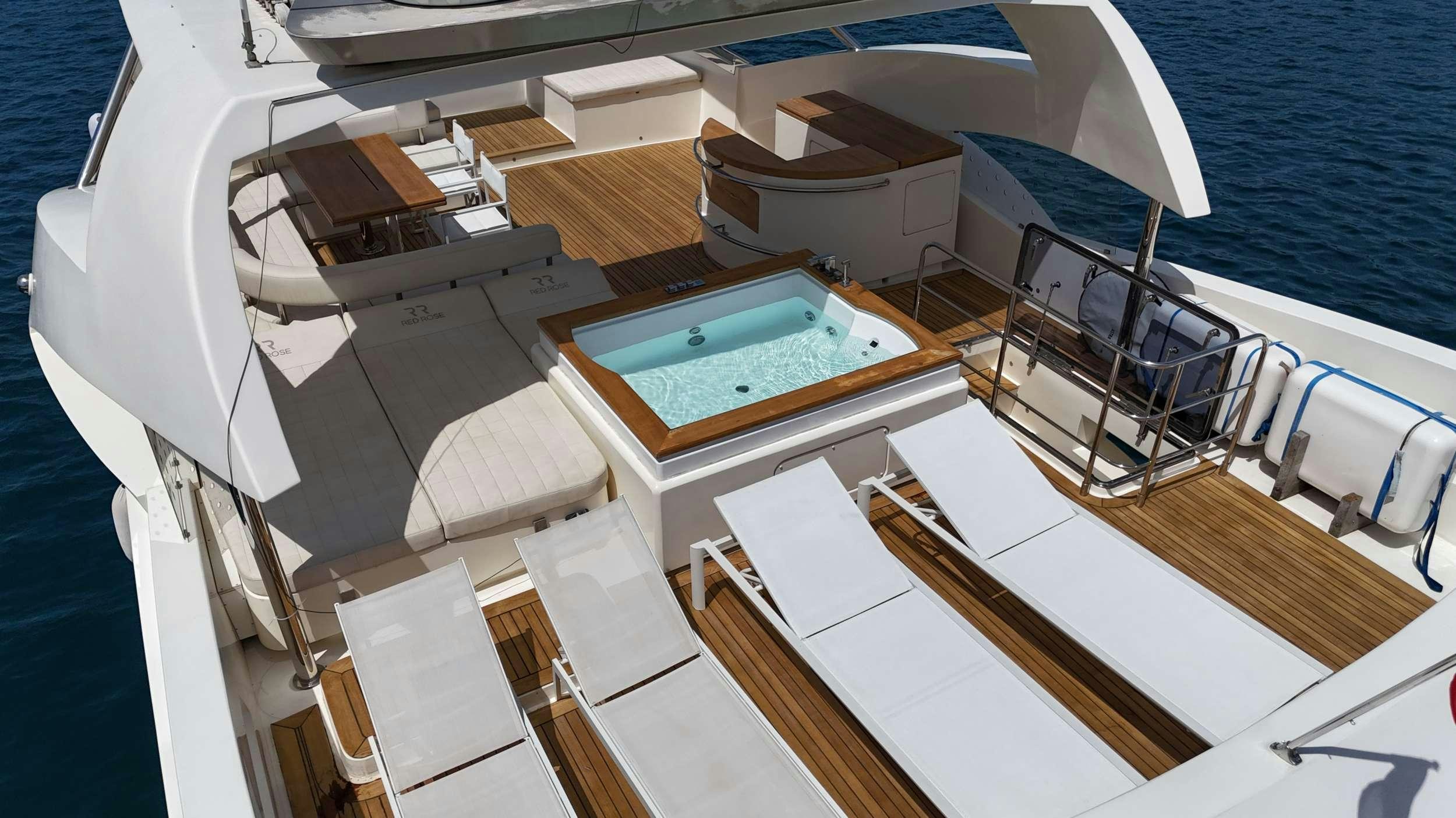 a boat with a deck and chairs aboard RED ROSE Yacht for Charter