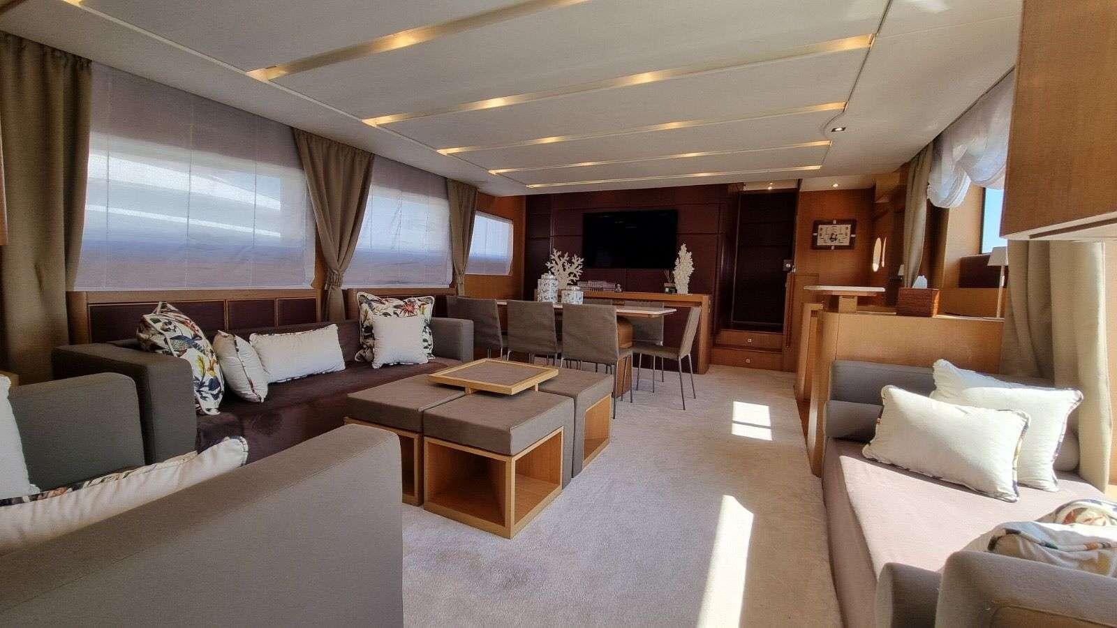 a room with couches and a table aboard RED ROSE Yacht for Charter