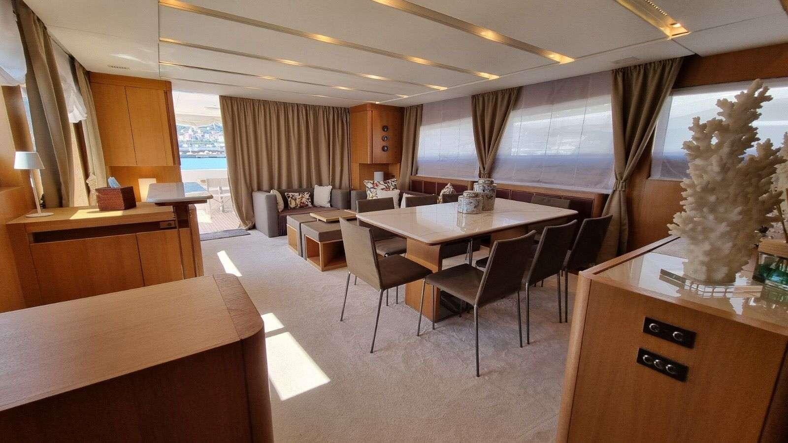 a room with tables and chairs aboard RED ROSE Yacht for Charter