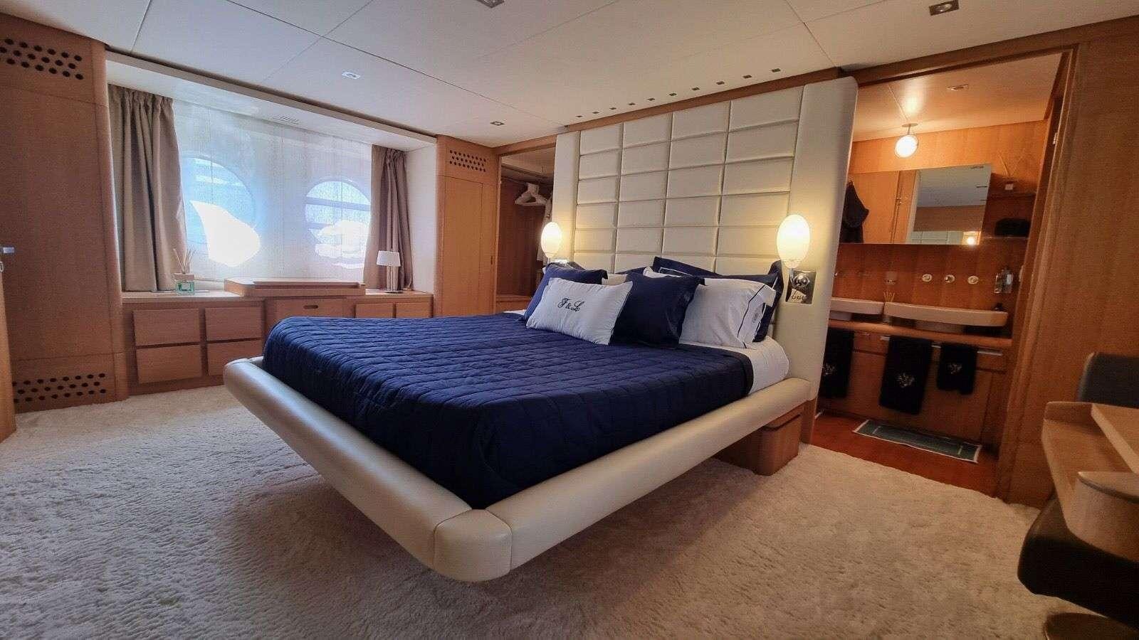 a large bedroom with a large bed aboard RED ROSE Yacht for Charter