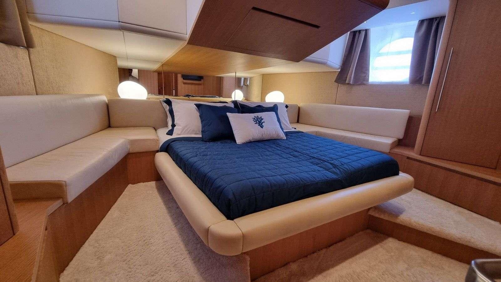 a room with a bed and a couch aboard RED ROSE Yacht for Charter