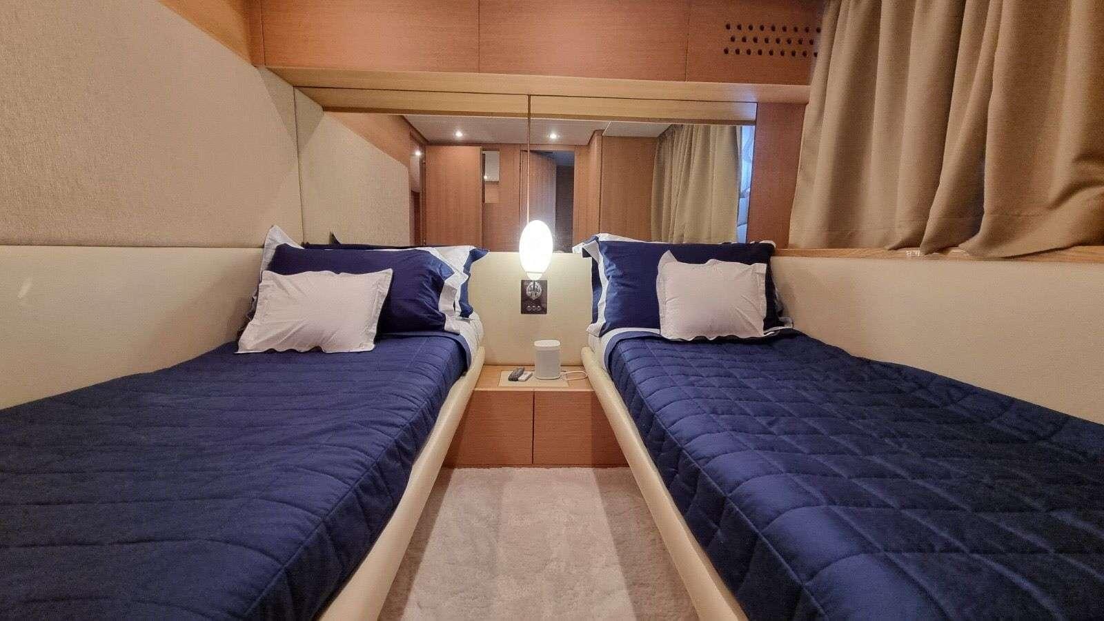a couple of beds in a hotel room aboard RED ROSE Yacht for Charter