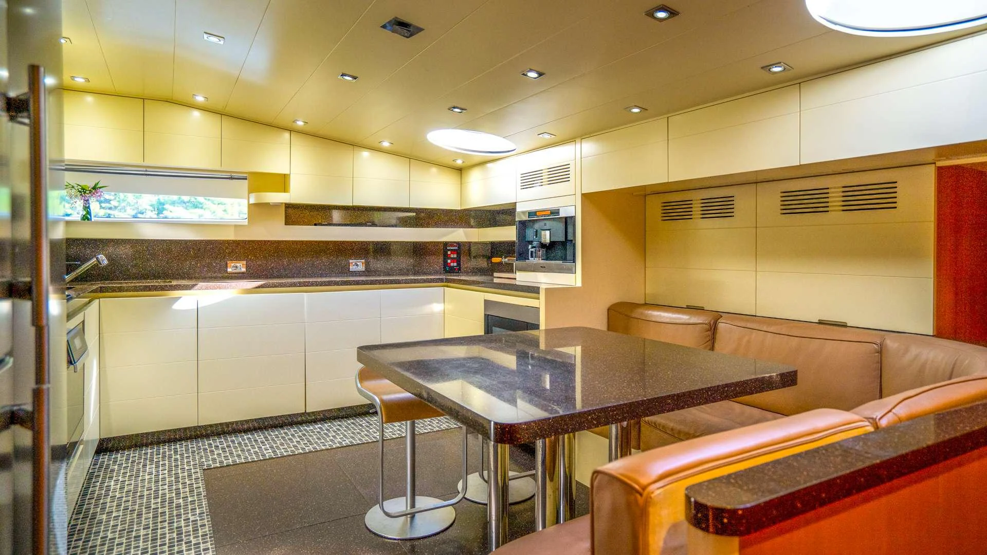 a kitchen with a table and couch aboard CYNTHIA Yacht for Charter