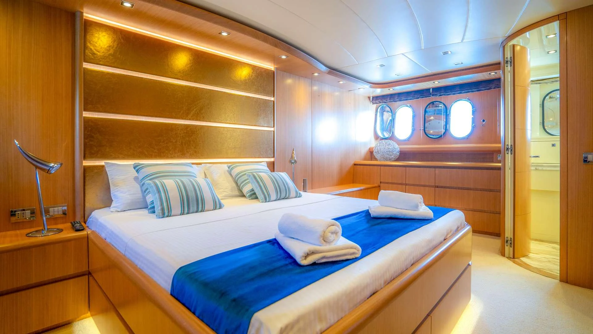 a room with a bed and a desk aboard CYNTHIA Yacht for Charter