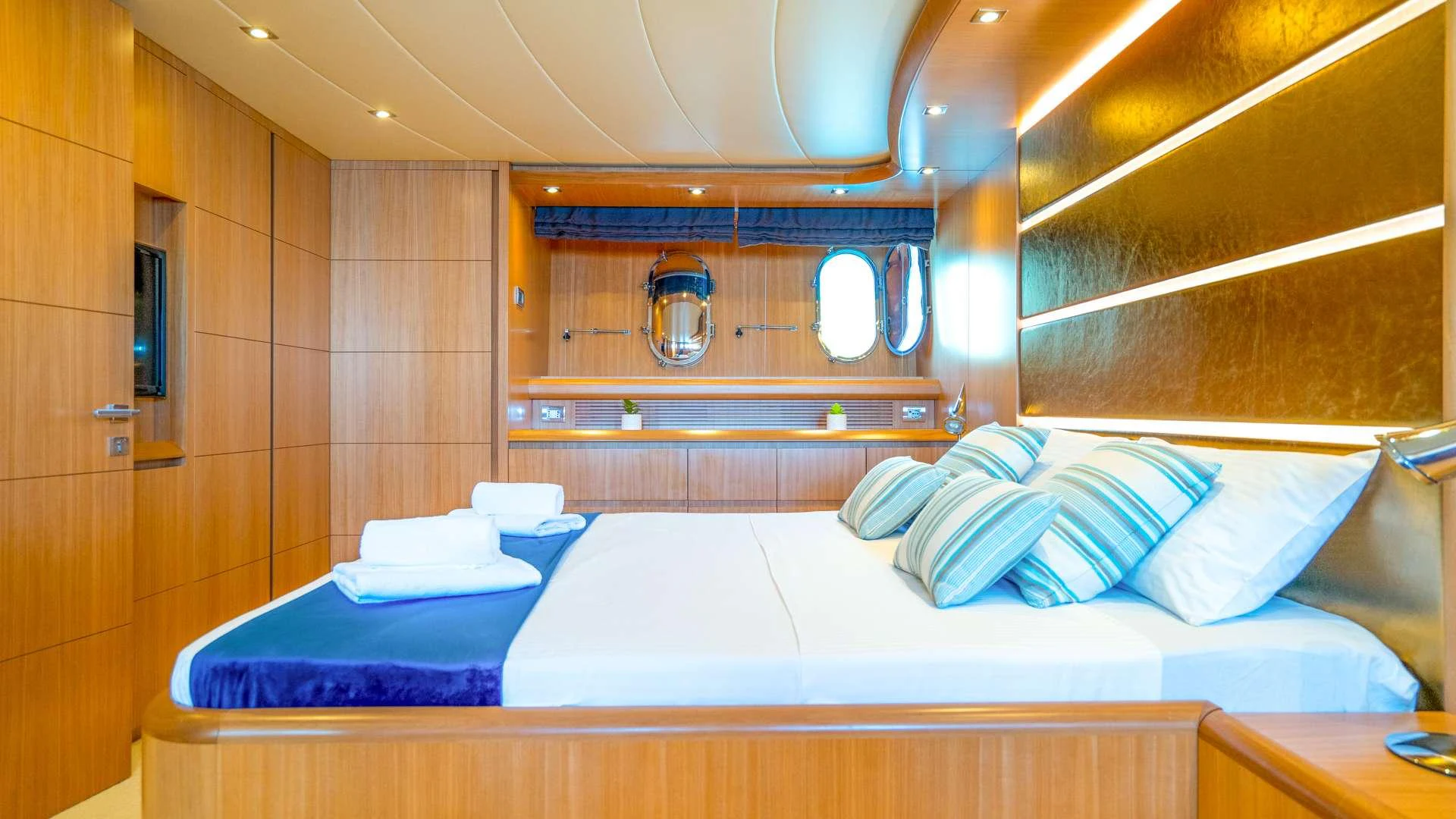 a room with a bed and a mirror aboard CYNTHIA Yacht for Charter