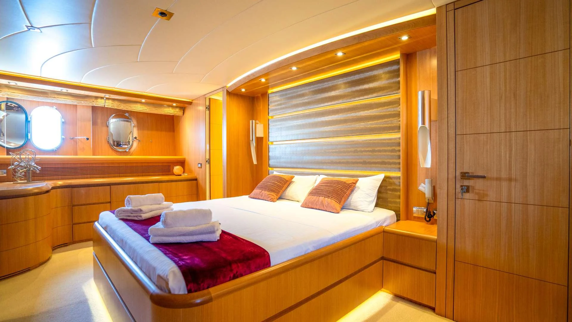 a room with a bed and a mirror aboard CYNTHIA Yacht for Charter