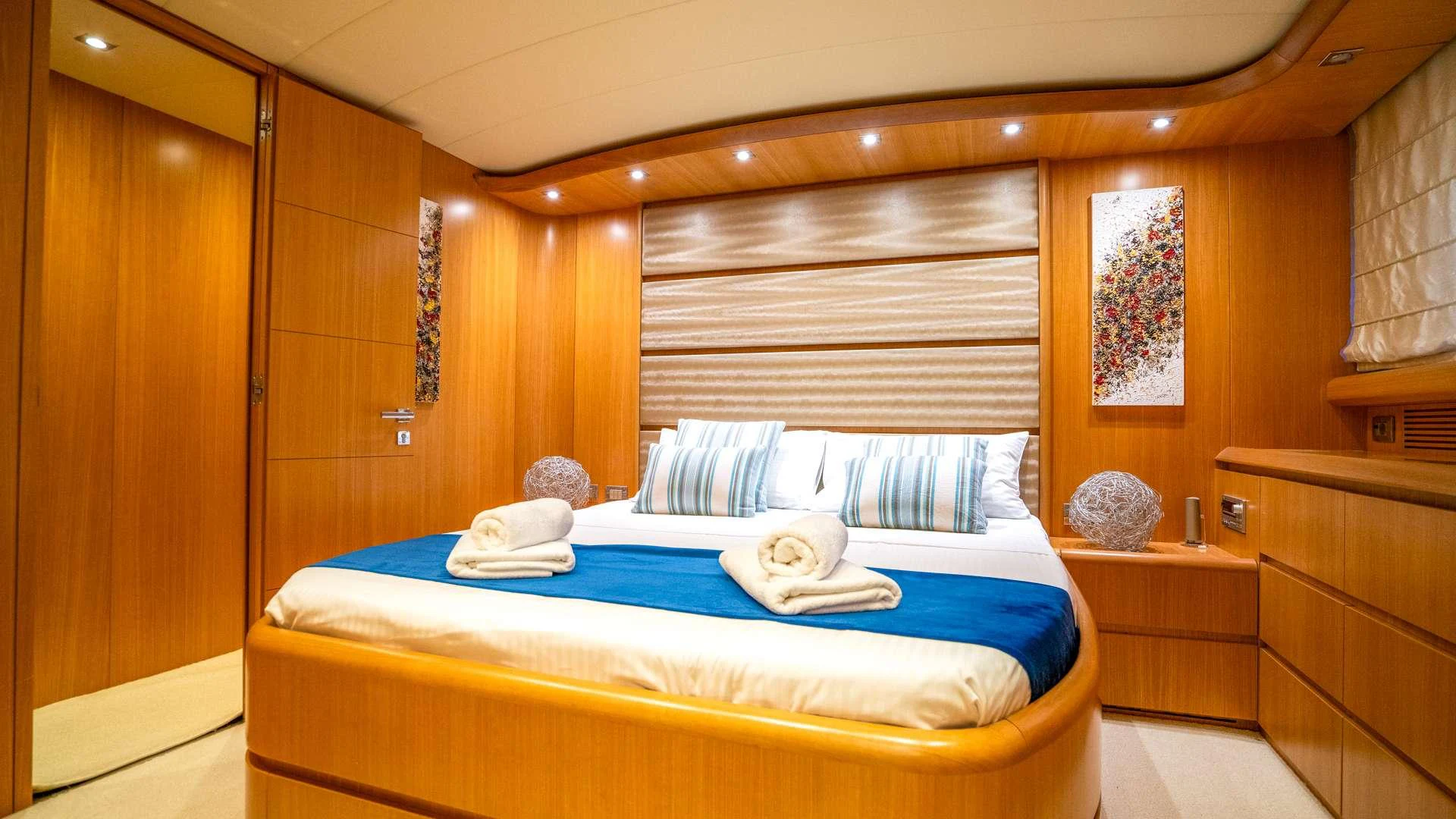 a bed with a blue sheet aboard CYNTHIA Yacht for Charter