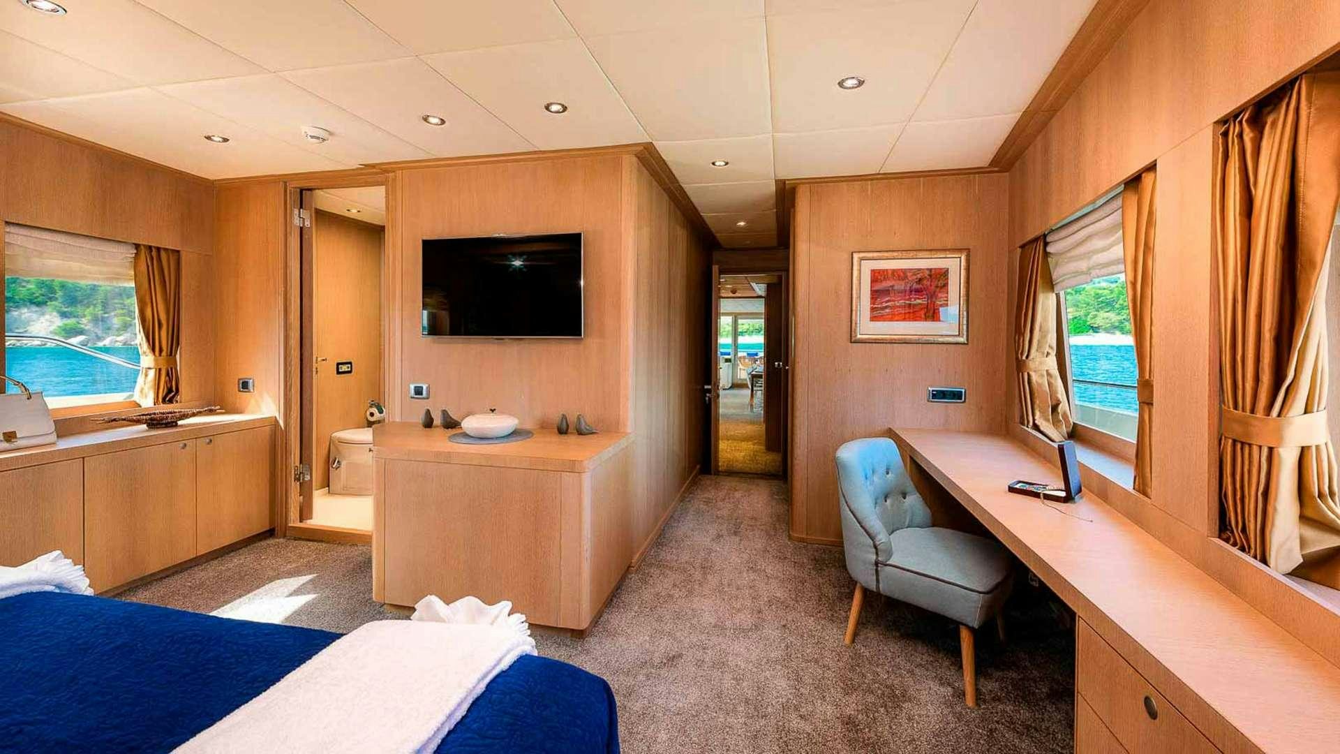 a room with a desk and a tv aboard GRACE Yacht for Charter