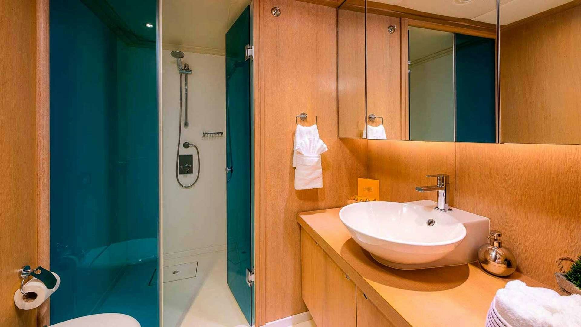 a bathroom with a sink and a shower aboard GRACE Yacht for Charter