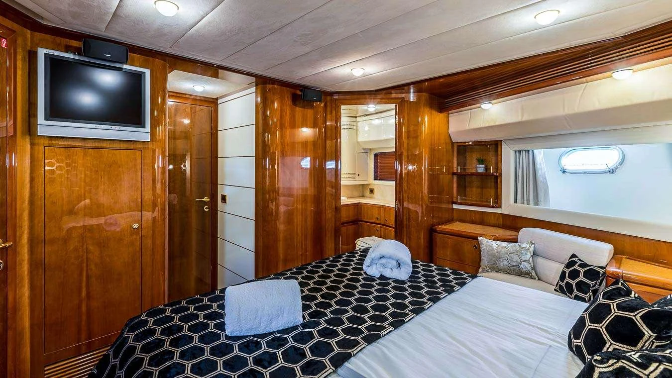a bedroom with a bed and a tv aboard KATARIINA Yacht for Charter