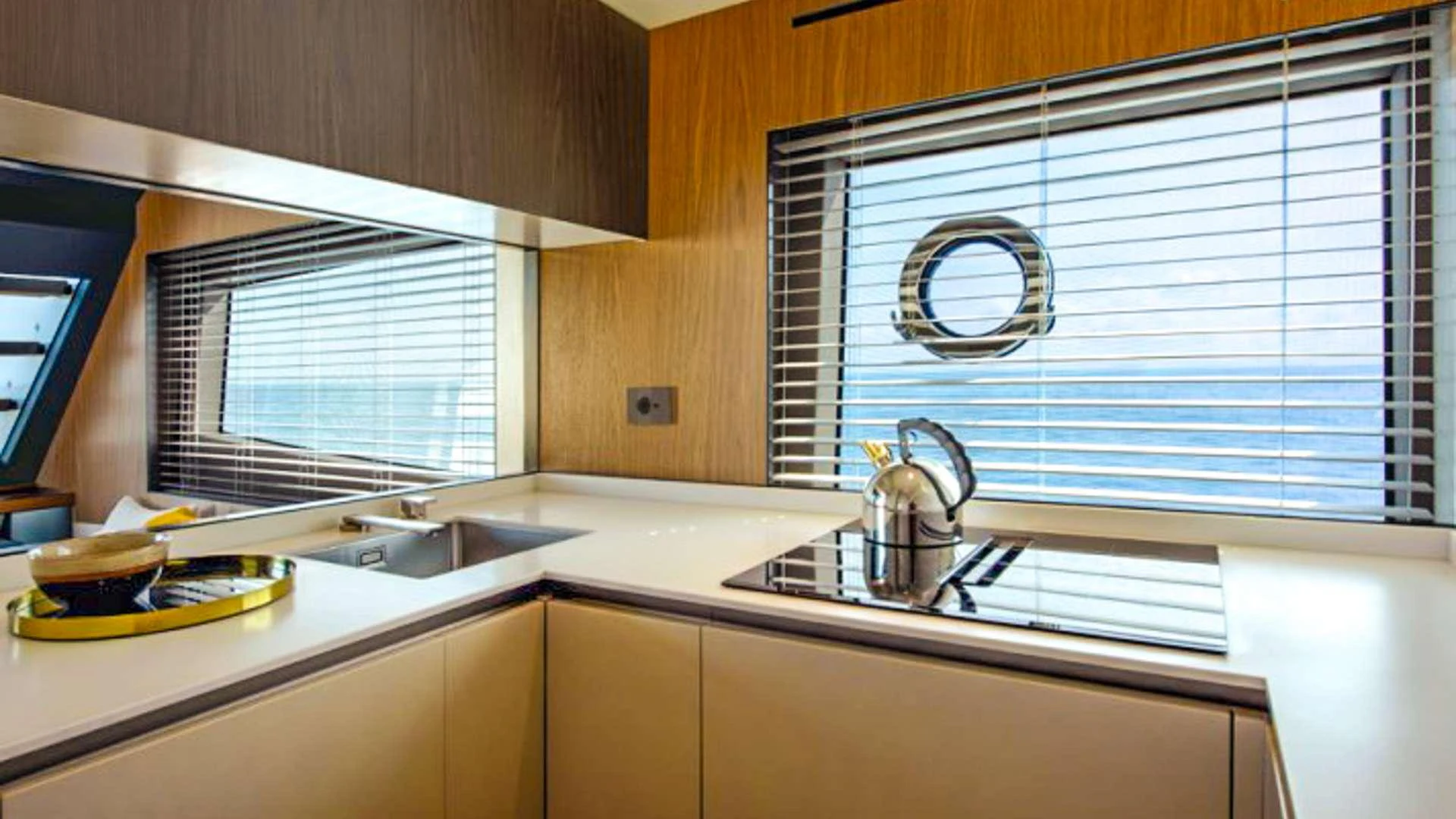 a kitchen with a sink and a window aboard KIMANI Yacht for Charter