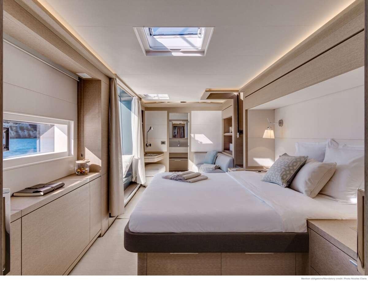 a bedroom with a bed and a tv aboard JAN'S FELINE Yacht for Charter