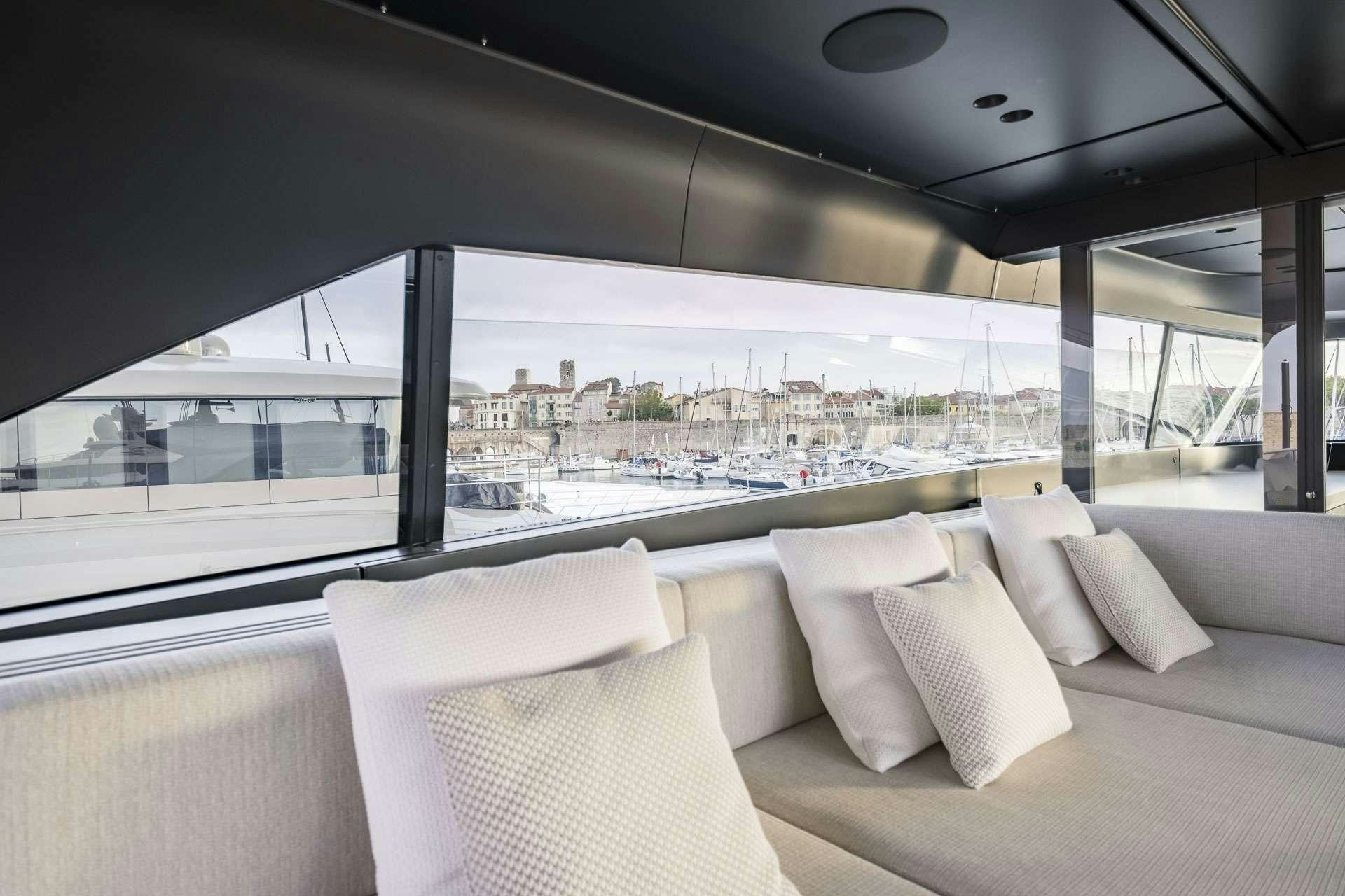 a room with a view of a city and a large window aboard SENSA Yacht for Charter