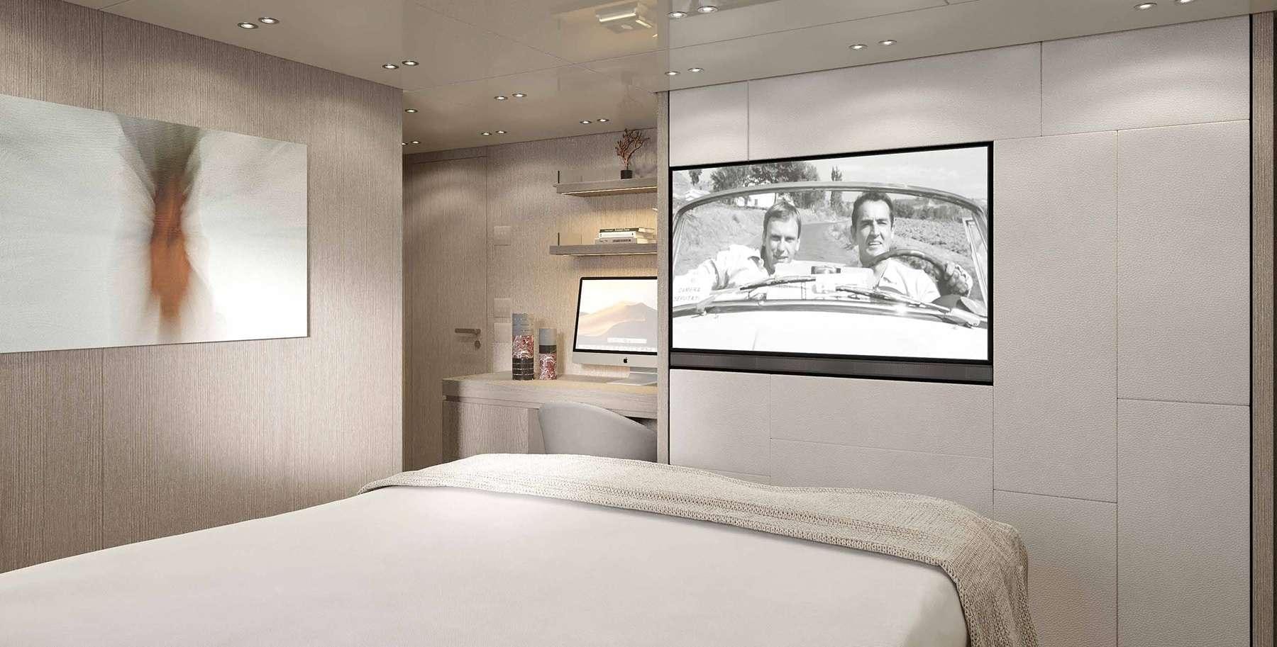 a bedroom with a bed and a tv on the wall aboard SENSA Yacht for Charter