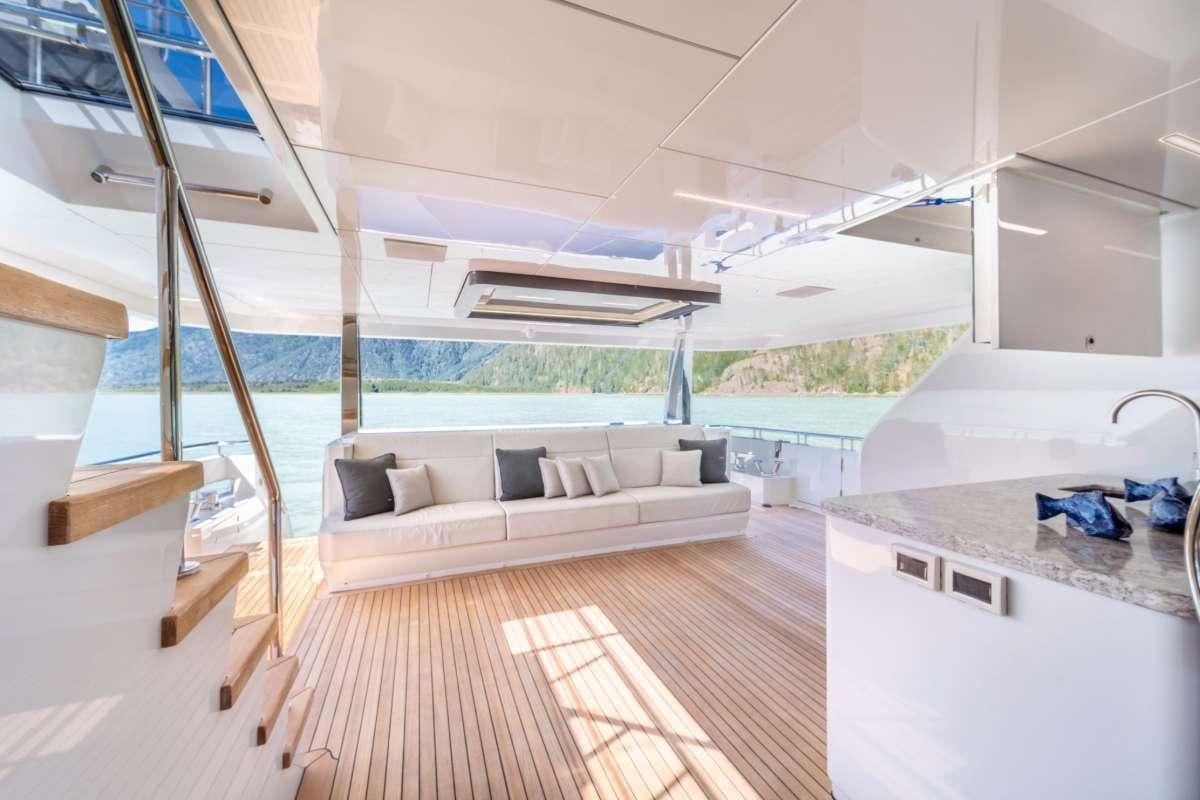 a room with a couch and a table and a pool aboard VOYAGER Yacht for Charter