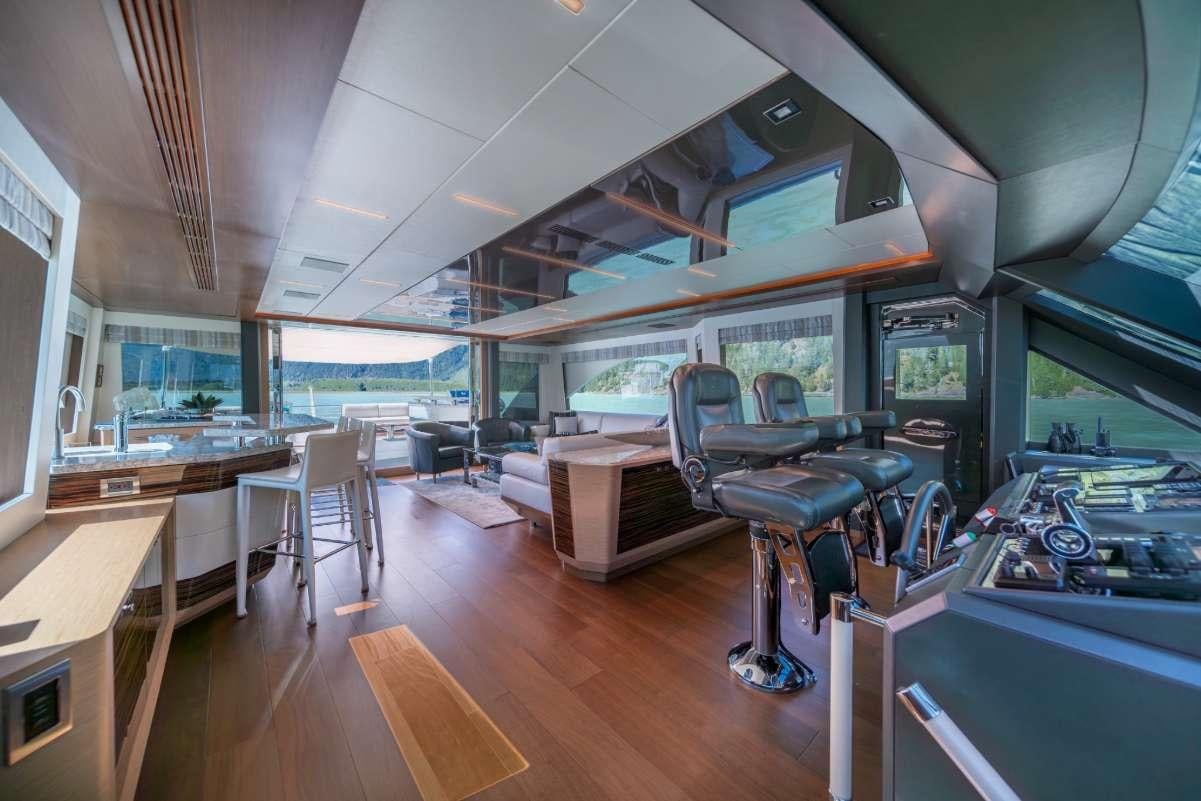 a room with a table chairs and a large window aboard VOYAGER Yacht for Charter