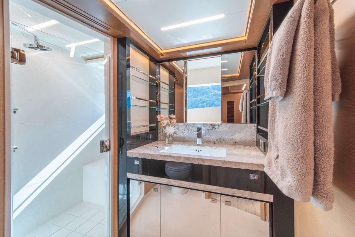 a bathroom with a sink and towels aboard VOYAGER Yacht for Charter