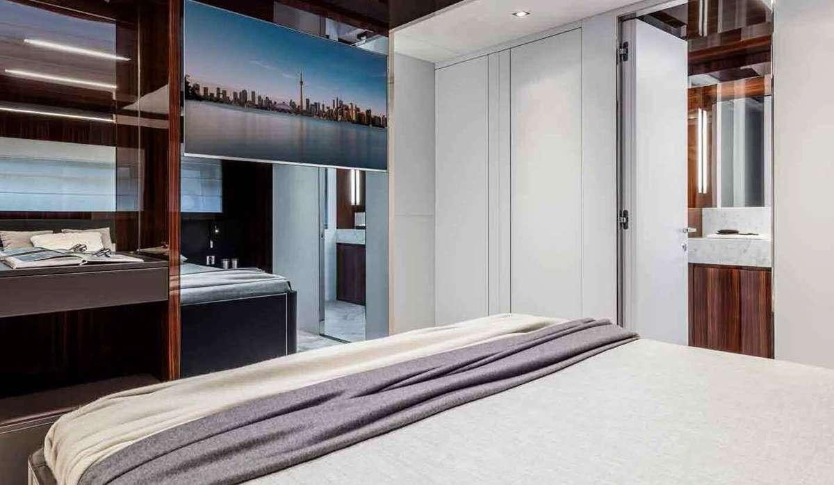 a room with a bed and a desk aboard BELLA DONNA Yacht for Charter