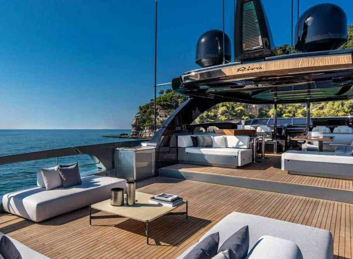 a deck with a view of the ocean and a large building aboard BELLA DONNA Yacht for Charter