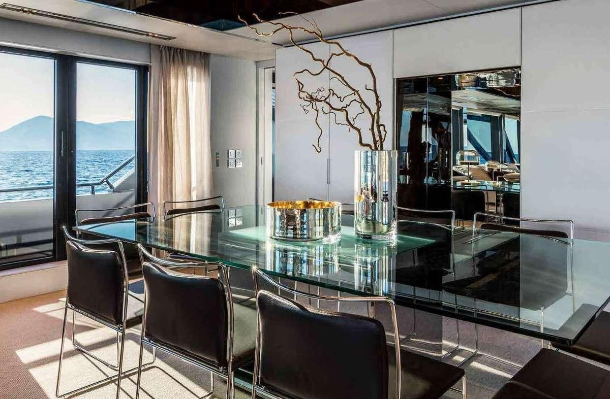 a table with chairs around it aboard BELLA DONNA Yacht for Charter