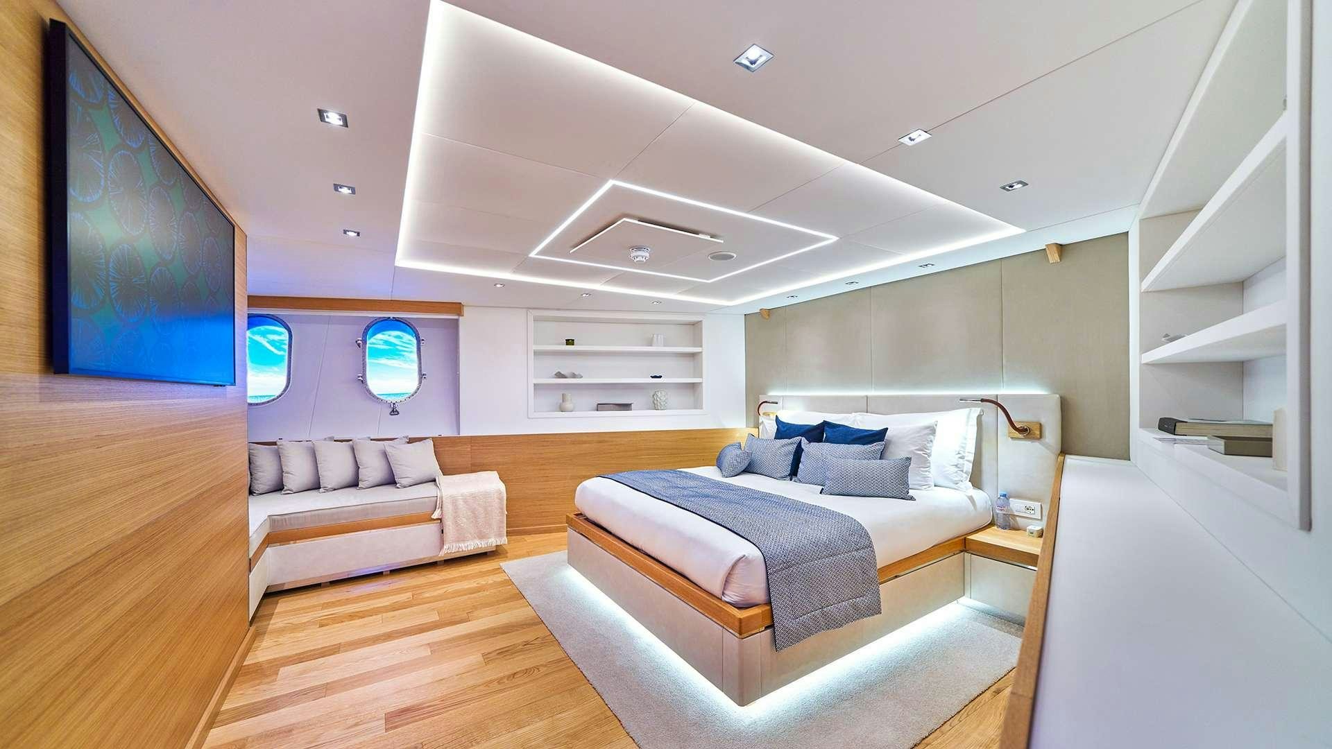 a room with a bed and a tv aboard ARGO Yacht for Charter