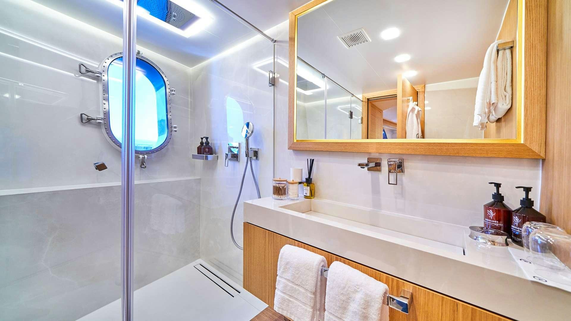 a bathroom with a large mirror aboard ARGO Yacht for Charter