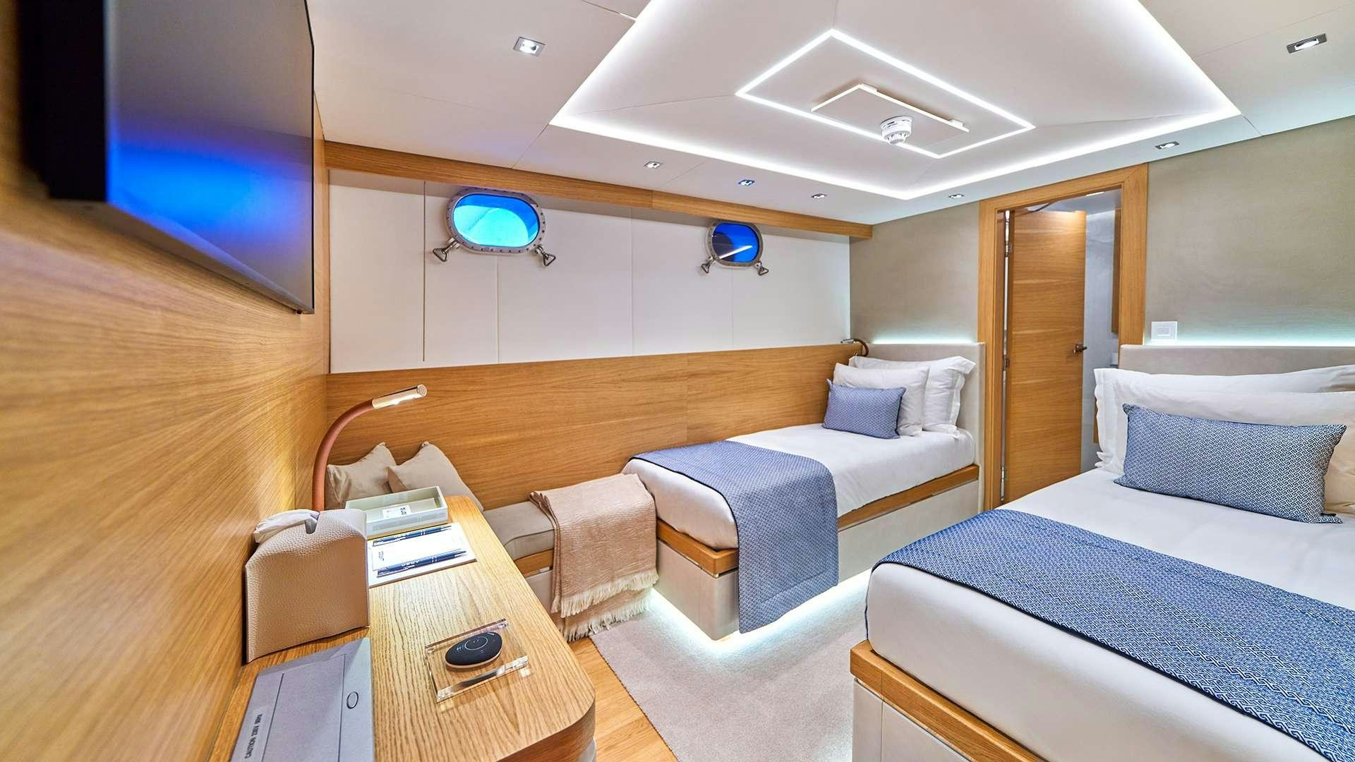 a room with a bed and a desk aboard ARGO Yacht for Charter