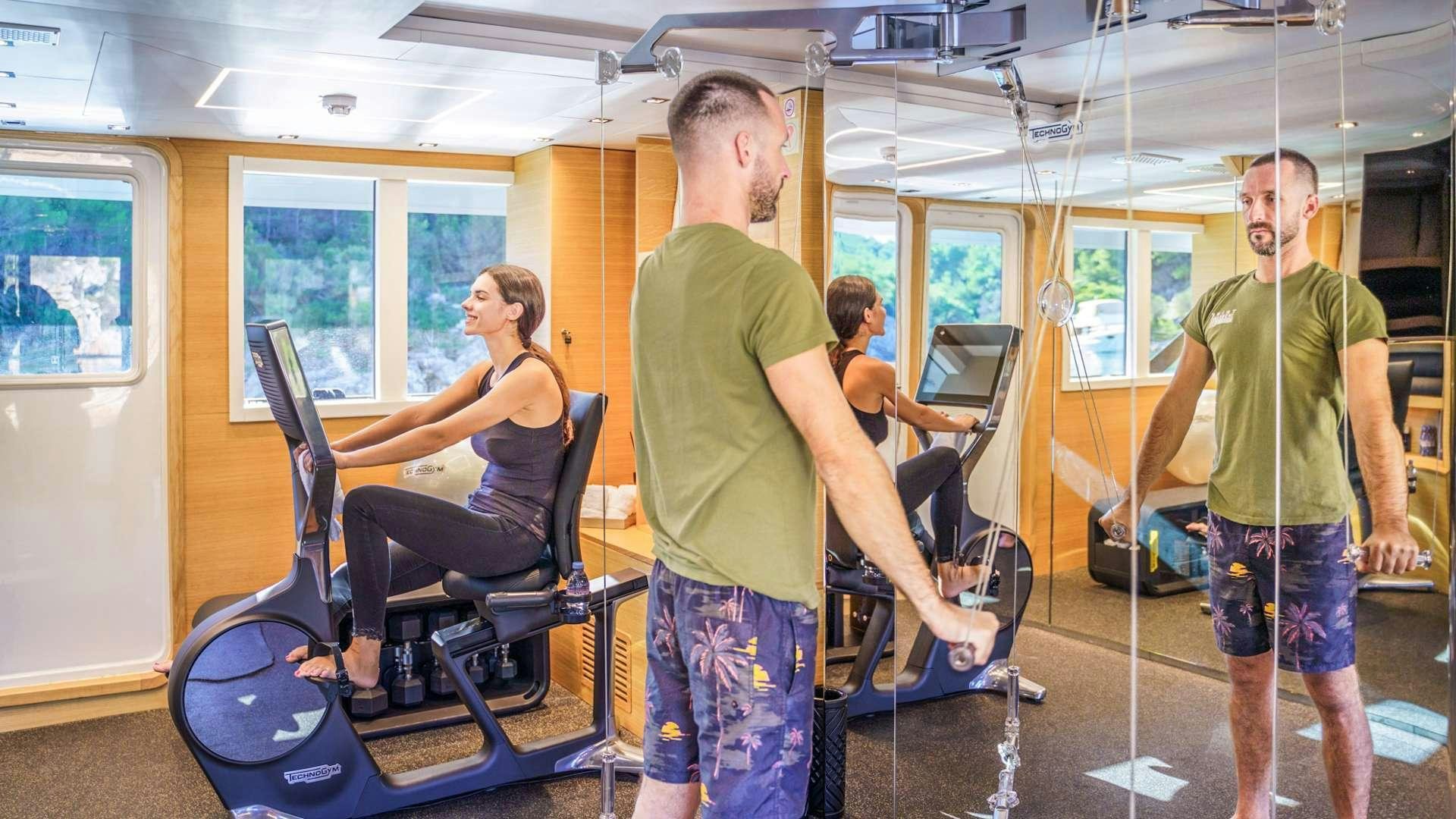 a group of people in a gym aboard ARGO Yacht for Charter