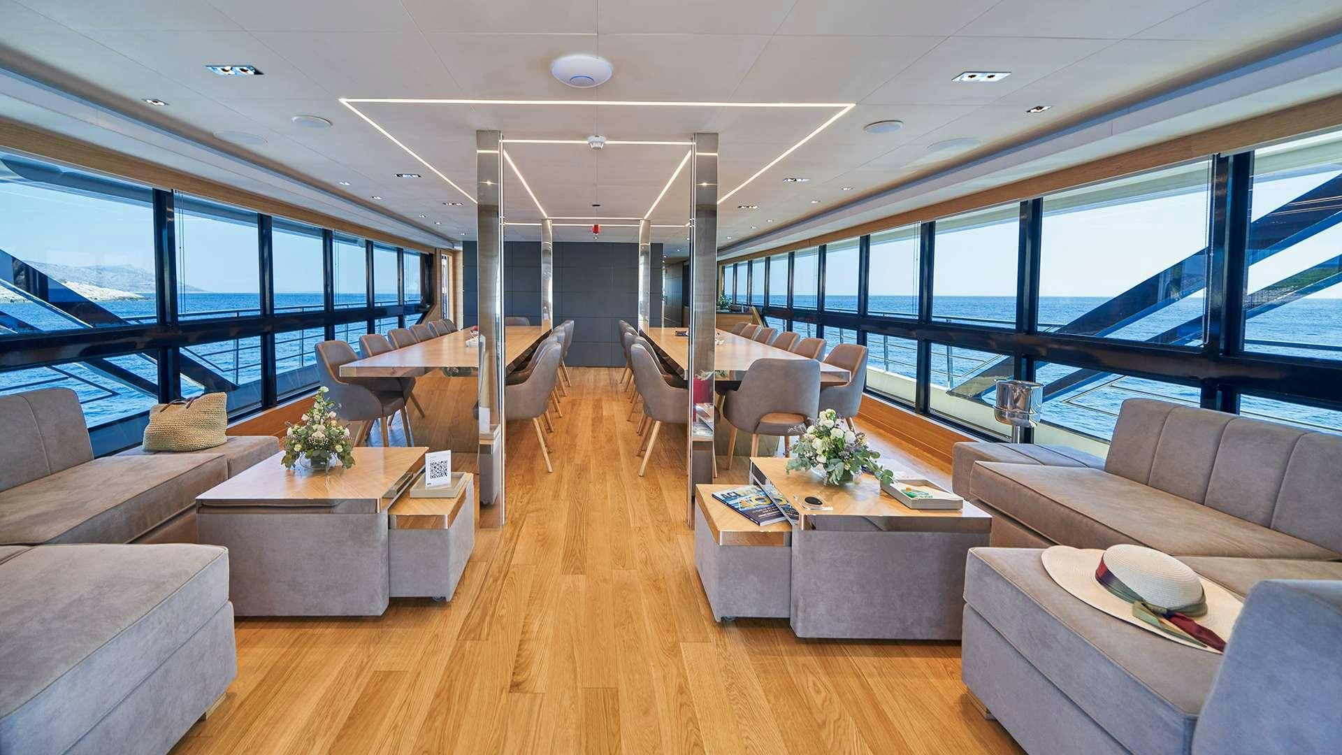 a living room with a wood floor aboard ARGO Yacht for Charter