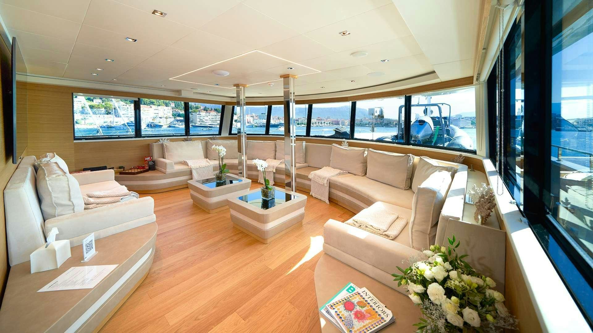 a living room with a large window aboard ARGO Yacht for Charter